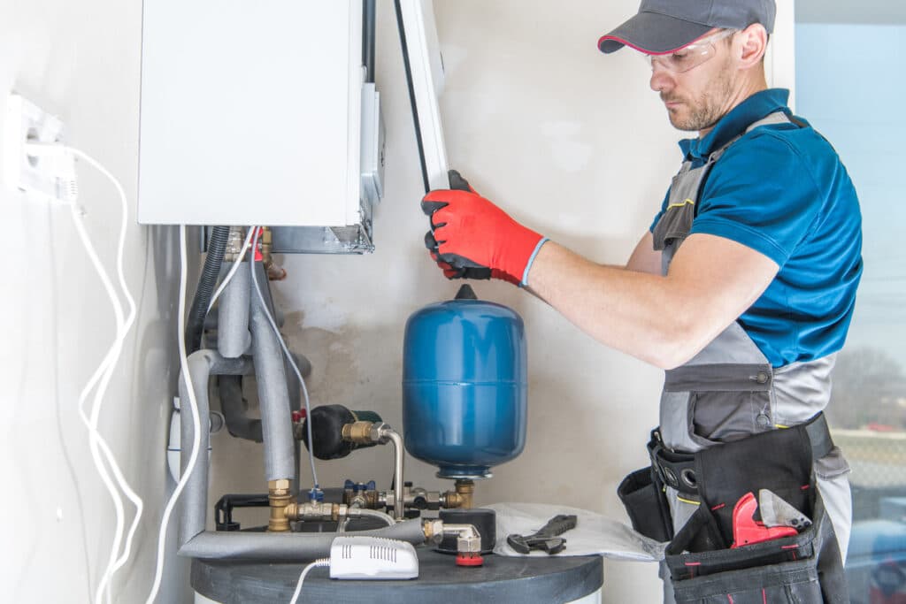 A technician installing a central gas heater