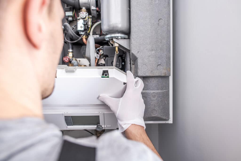 A technician repairing a furnace system